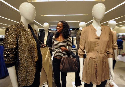 A woman looks at clothing displayed at the newly opened store of Africa
